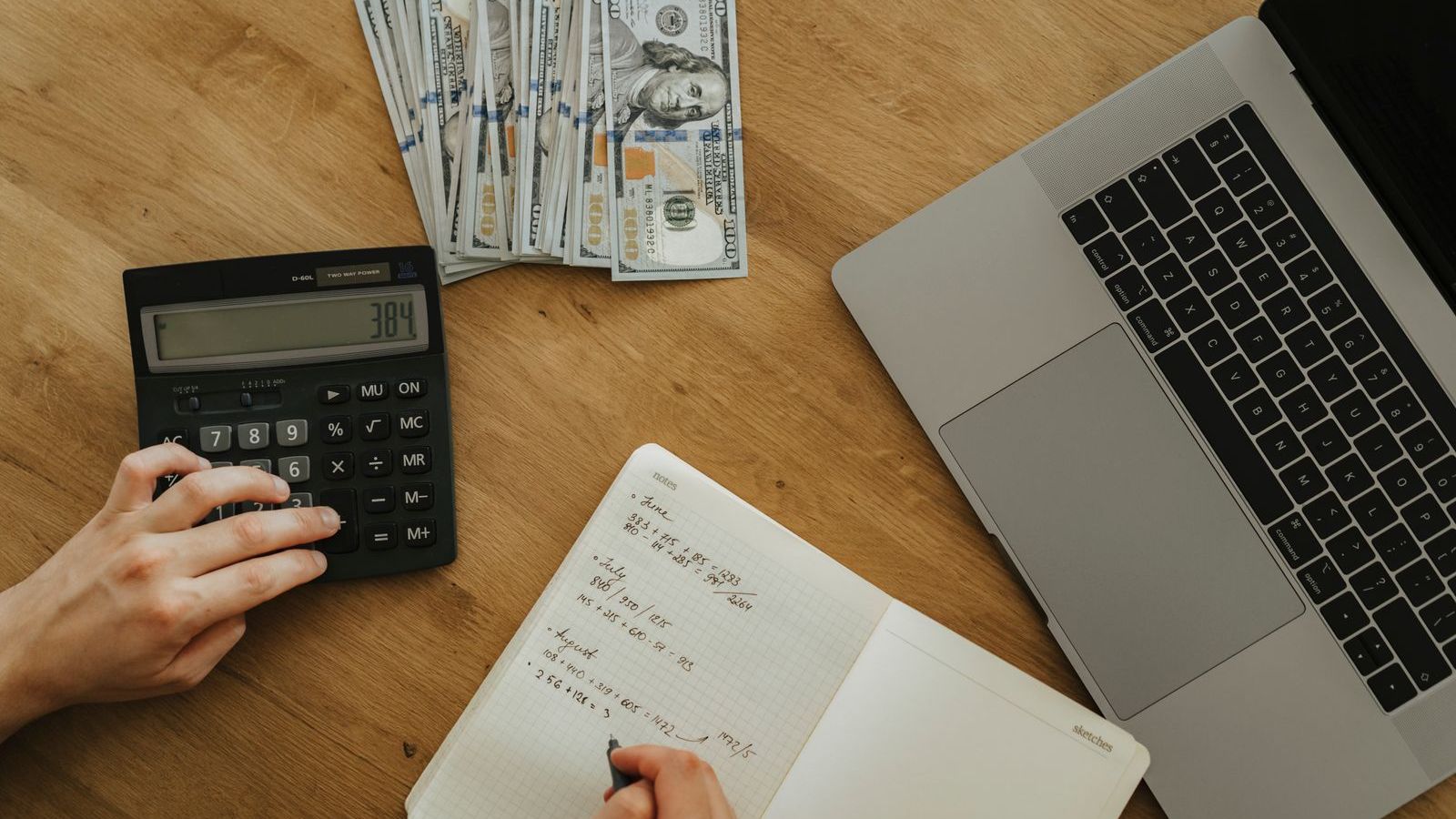 Person holding a desk calculator, representing budgeting and pricing for field force management software