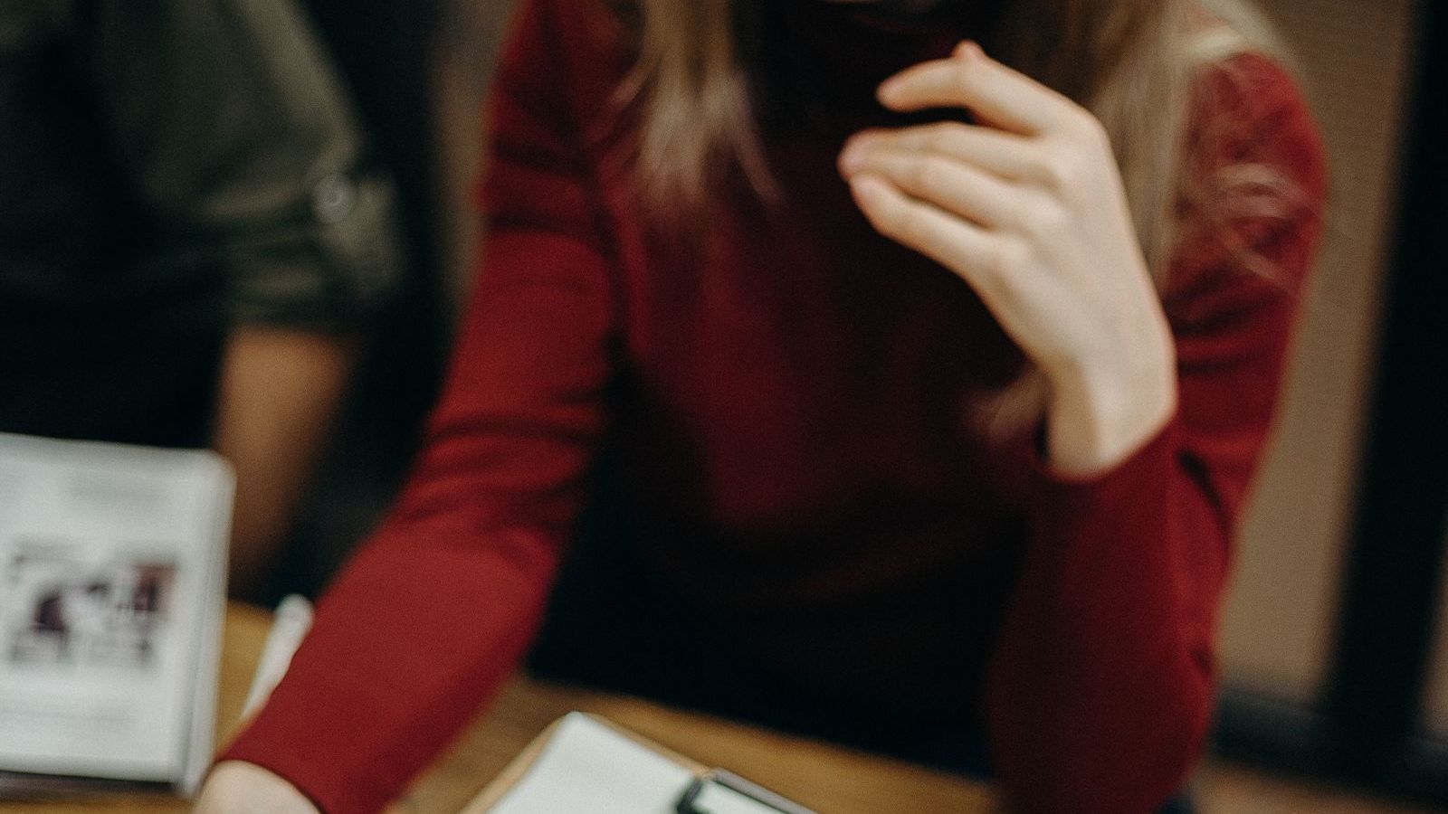 Woman holding a clipboard and filling a form, representing an insurance claim survey