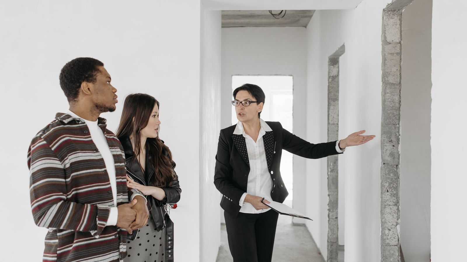 Real estate agent showing an apartment to a couple during a property visit