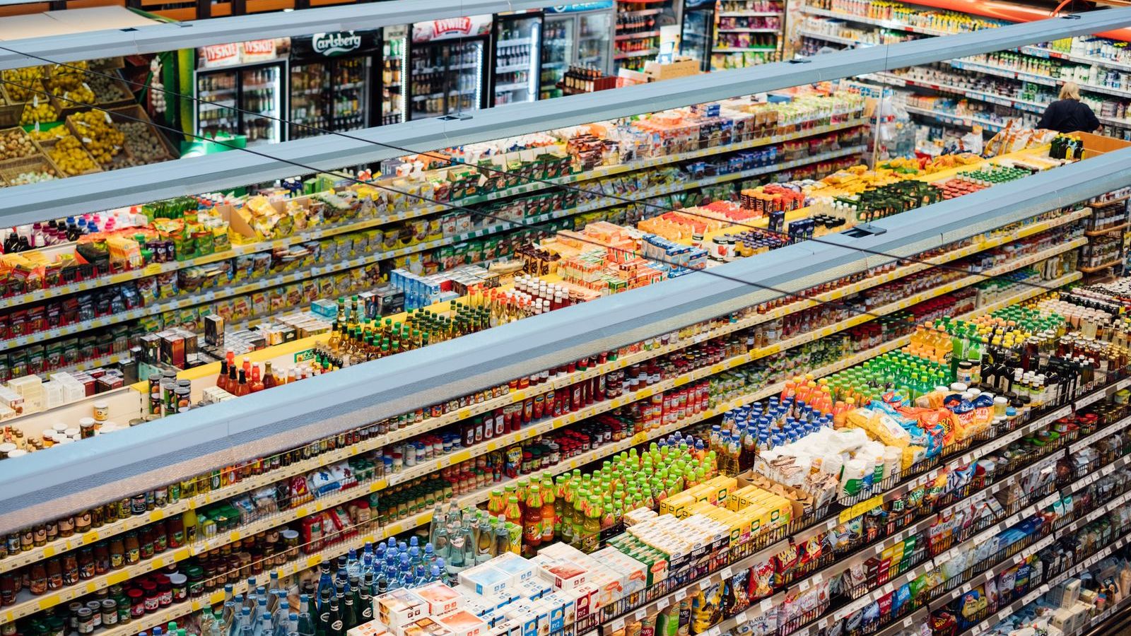 Store shelves stocked with packaged products, representing shelf audits and merchandising visits