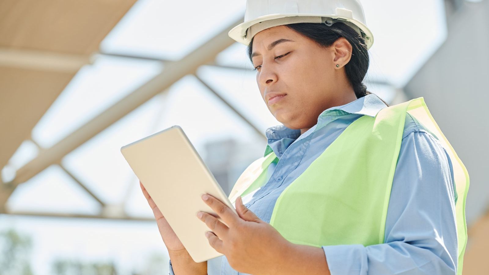 Engineer using a tablet on site to record and verify a customer visit